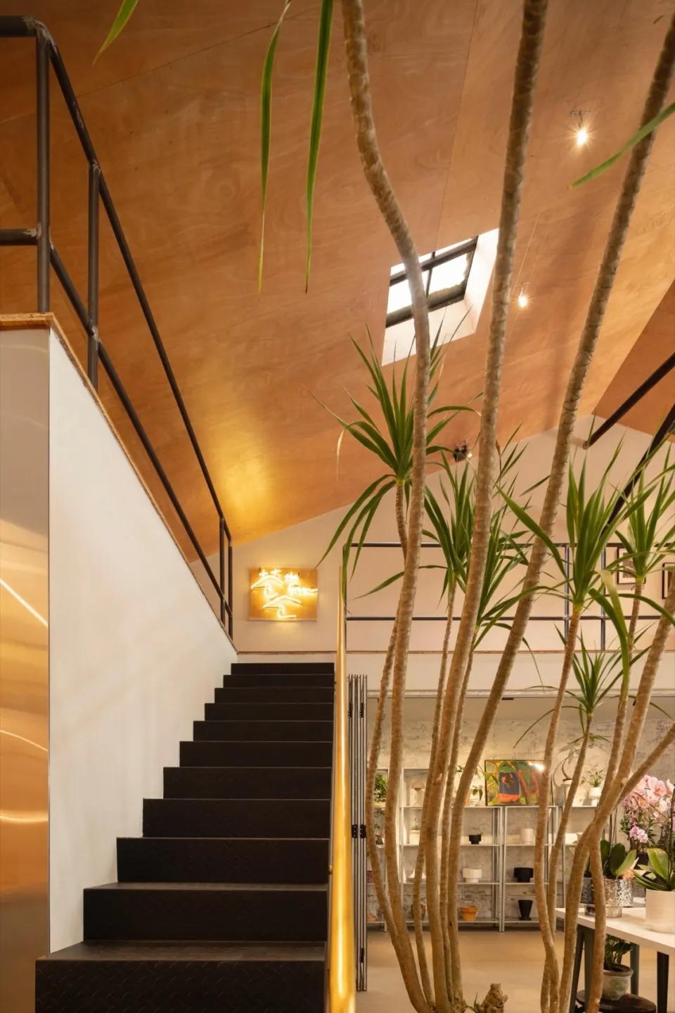 A modern interior space featuring metal railings and wooden elements.