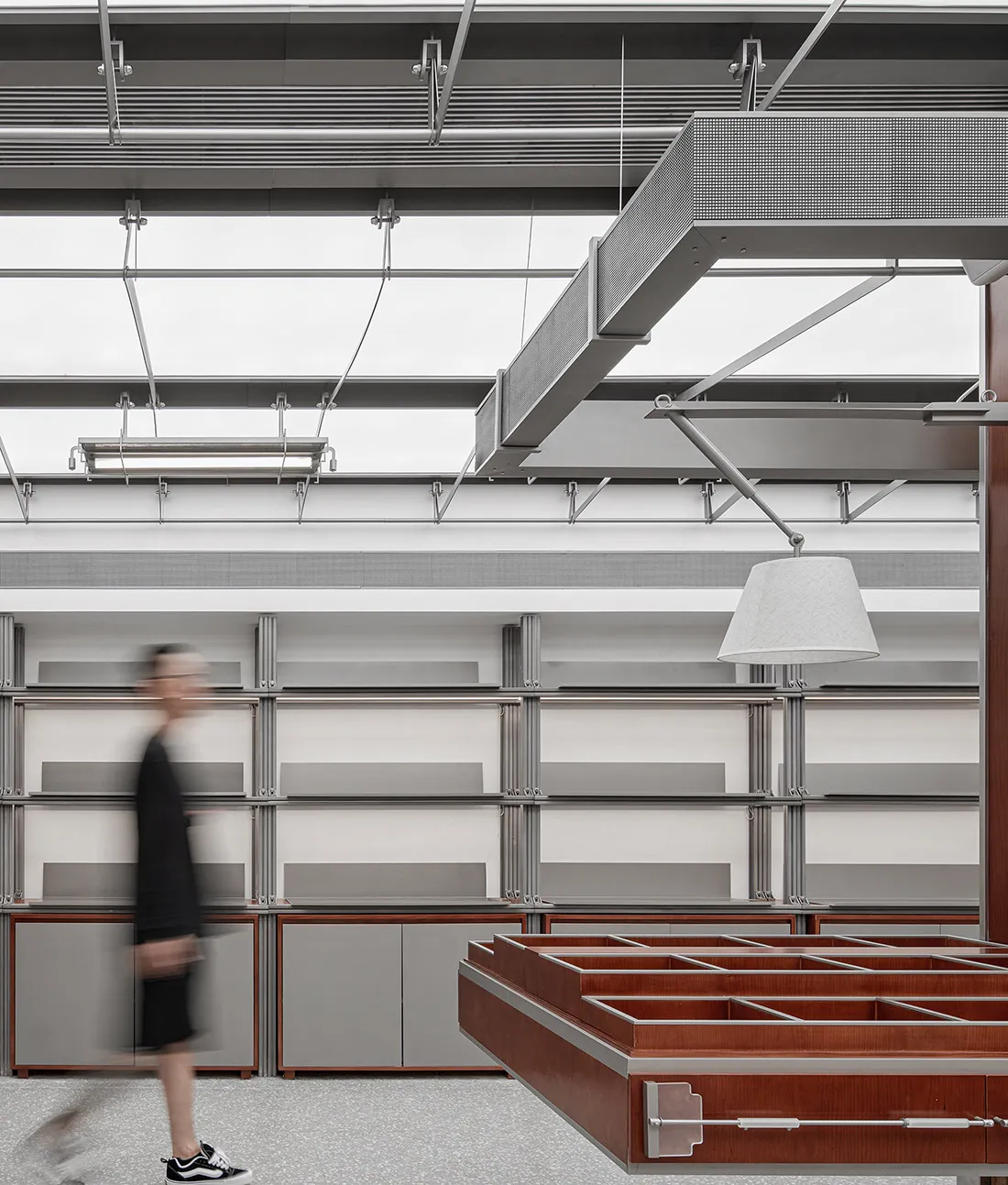 Modern showroom featuring industrial metal shelves and lighting fixtures.