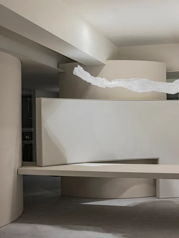 Modern minimalist interior design featuring polished concrete floors and walls.