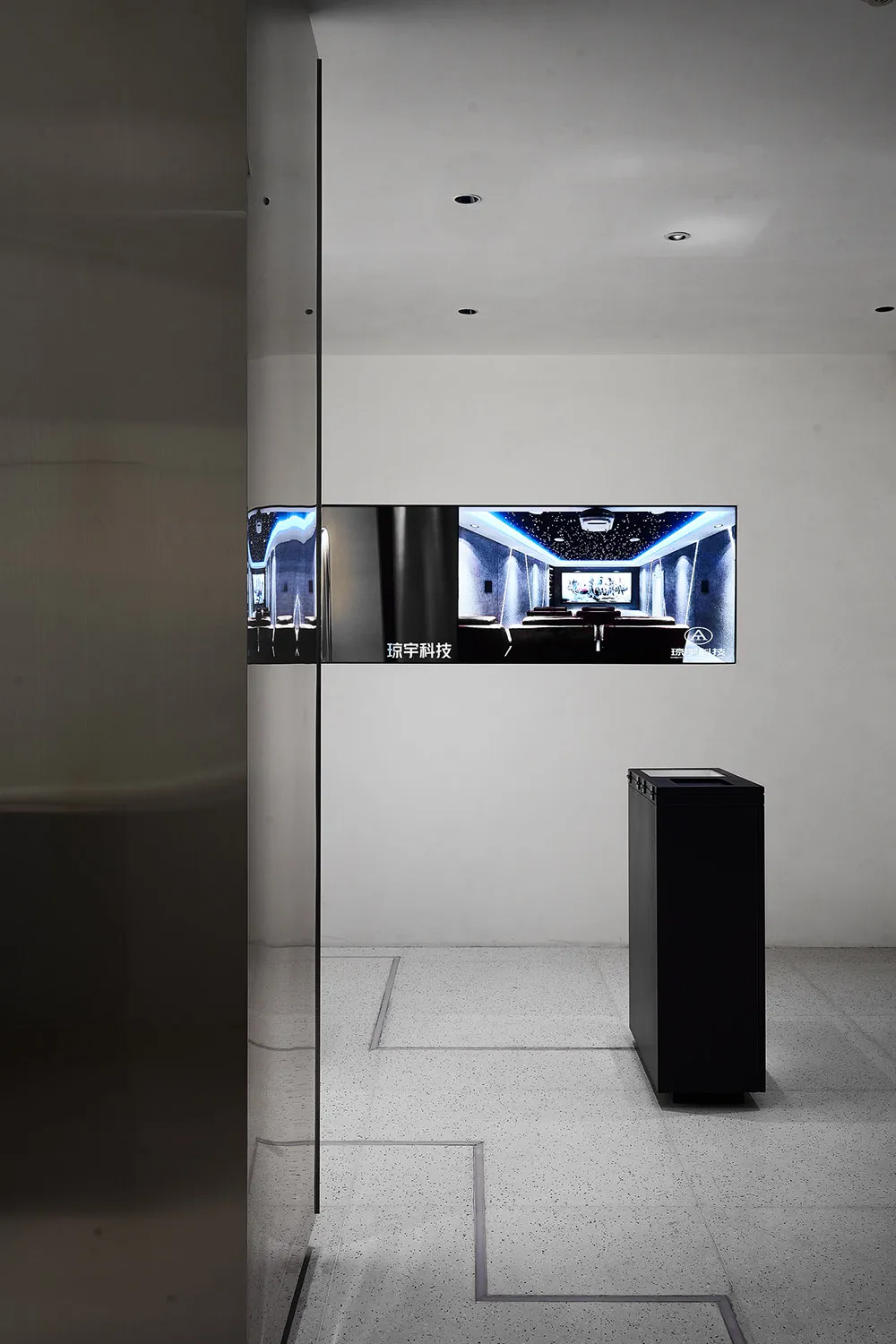 Modern minimalist interior with a glass display case and sleek, clean lines.