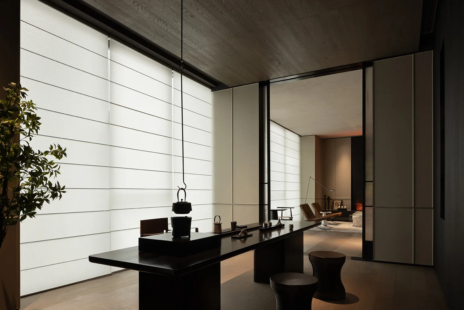 Modern minimalist coffee bar featuring dark wood tables and transparent glass elements.