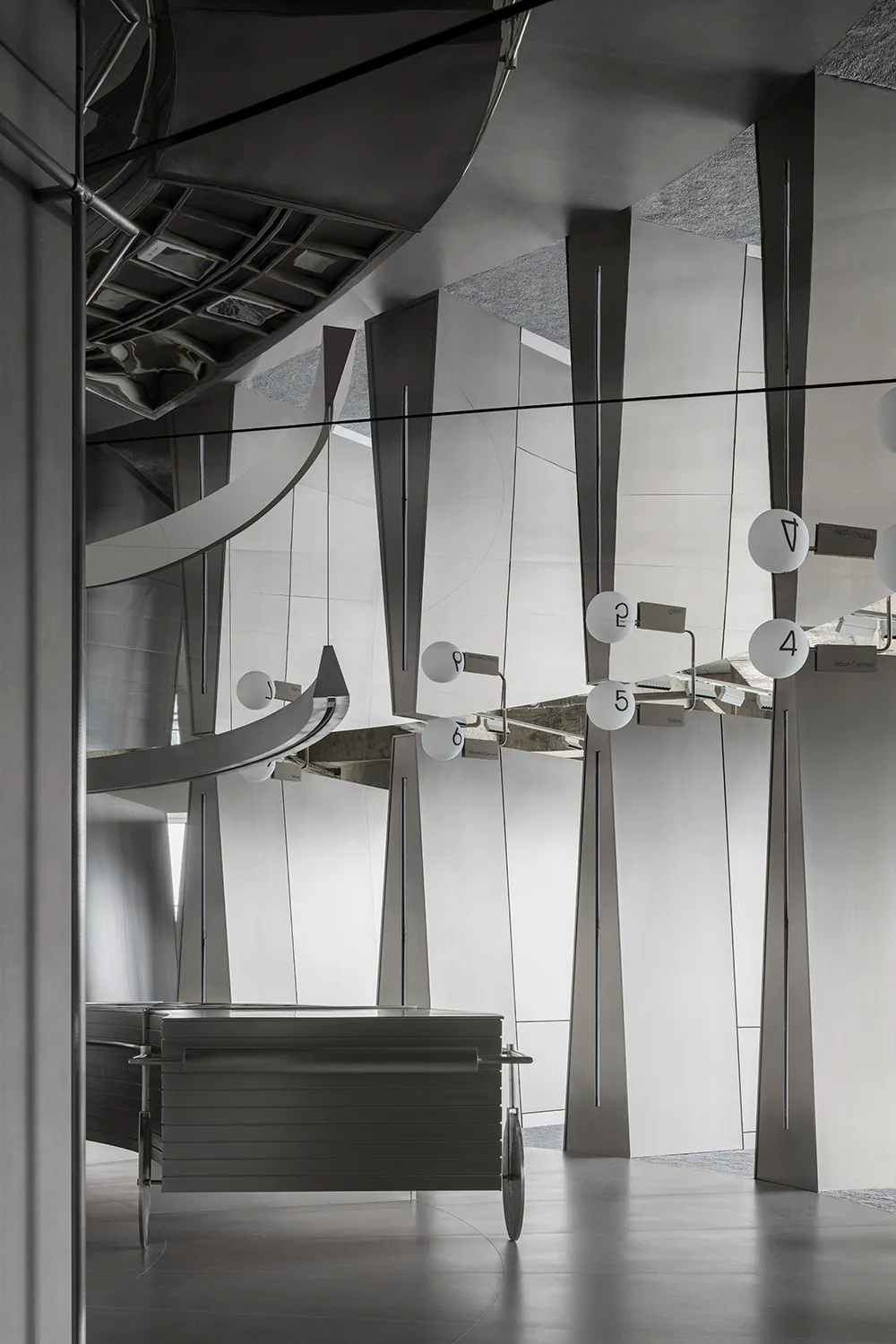 Scalene triangles made of metallic material create a unique and industrial design aesthetic in a corporate space.