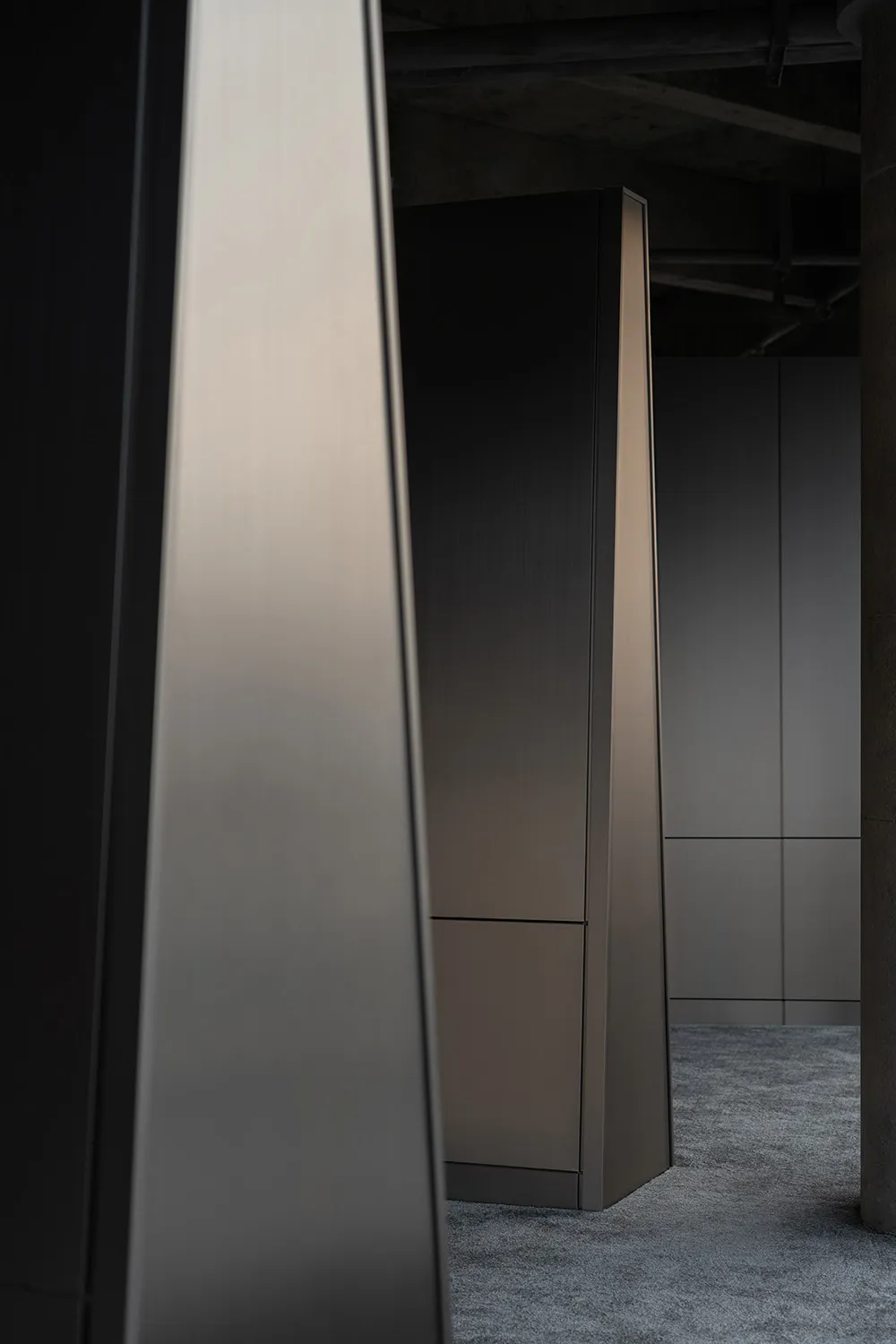 A modern, minimalist closet with metallic finish, featuring sleek lines and a monochromatic color palette, designed for effic