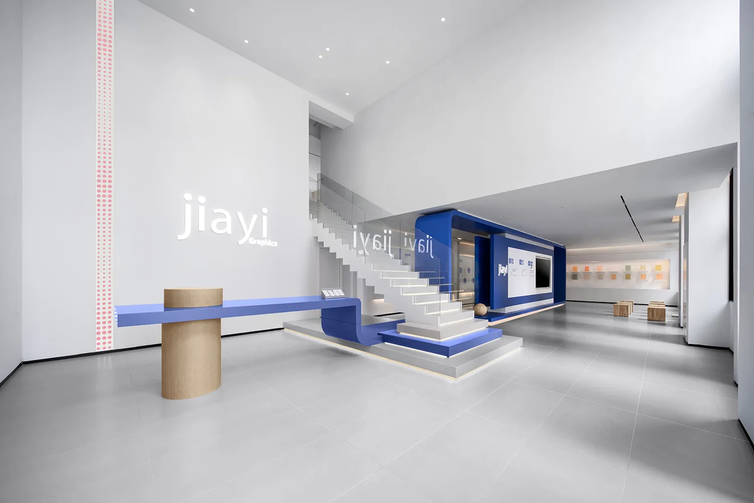 A modern office with blue and white stairs and a clean, minimalist design.