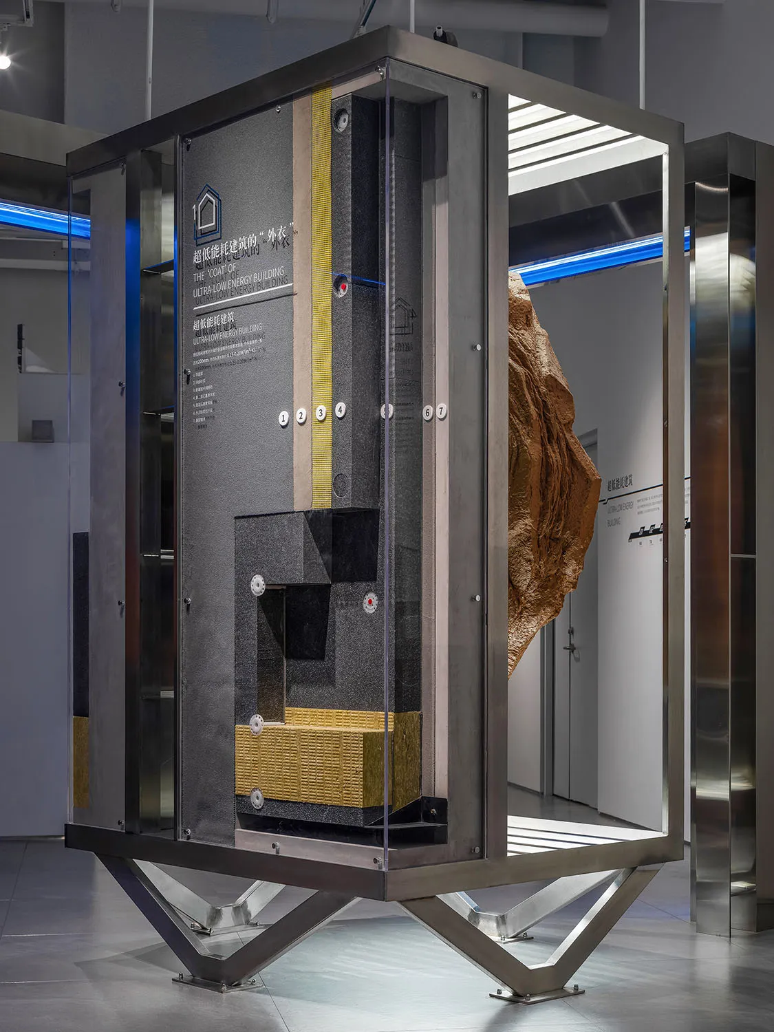 An ultra-low energy building model showcasing insulation materials inside a metallic frame.