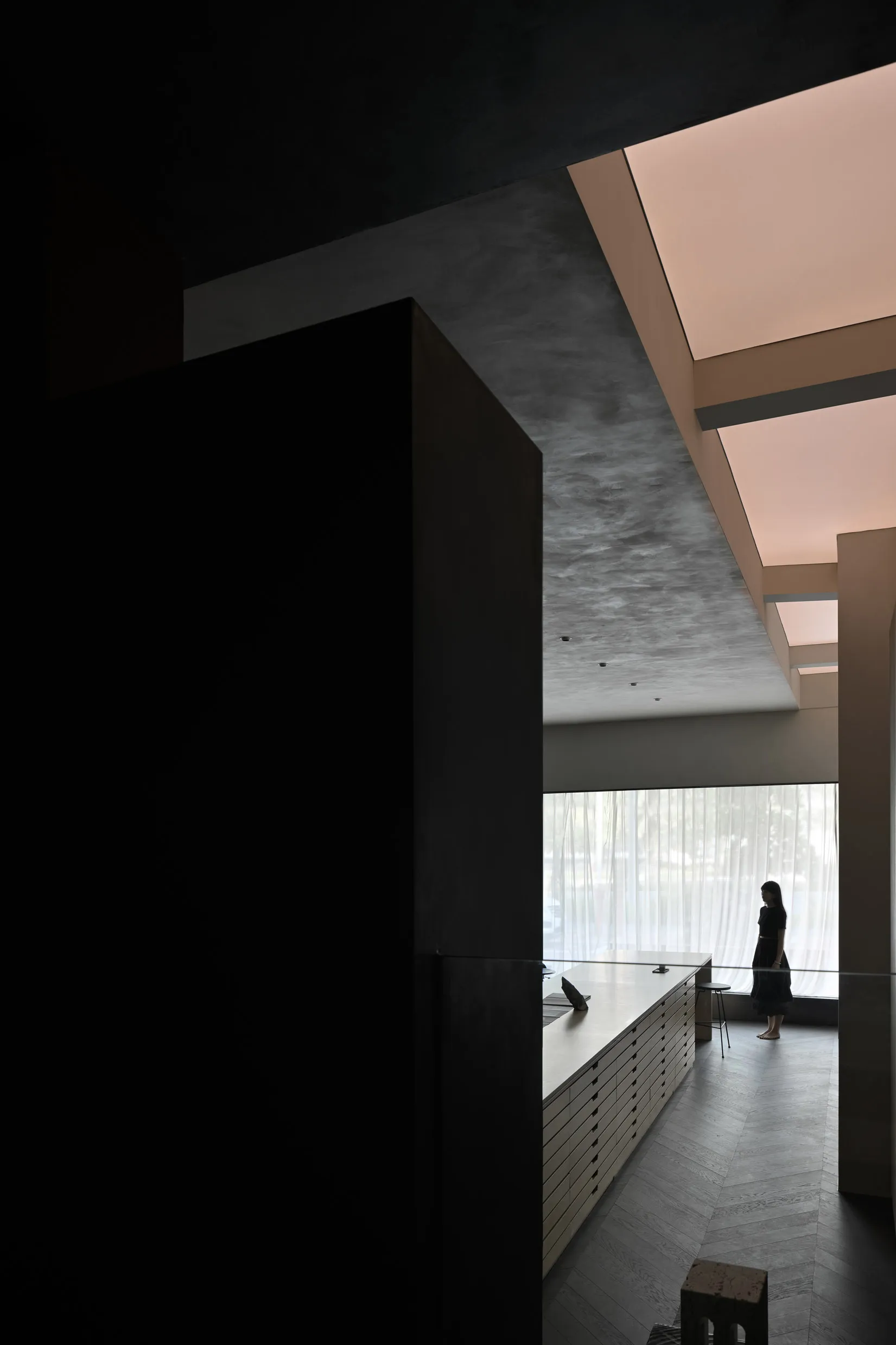 A modern office interior with concrete materials and a minimalist design.