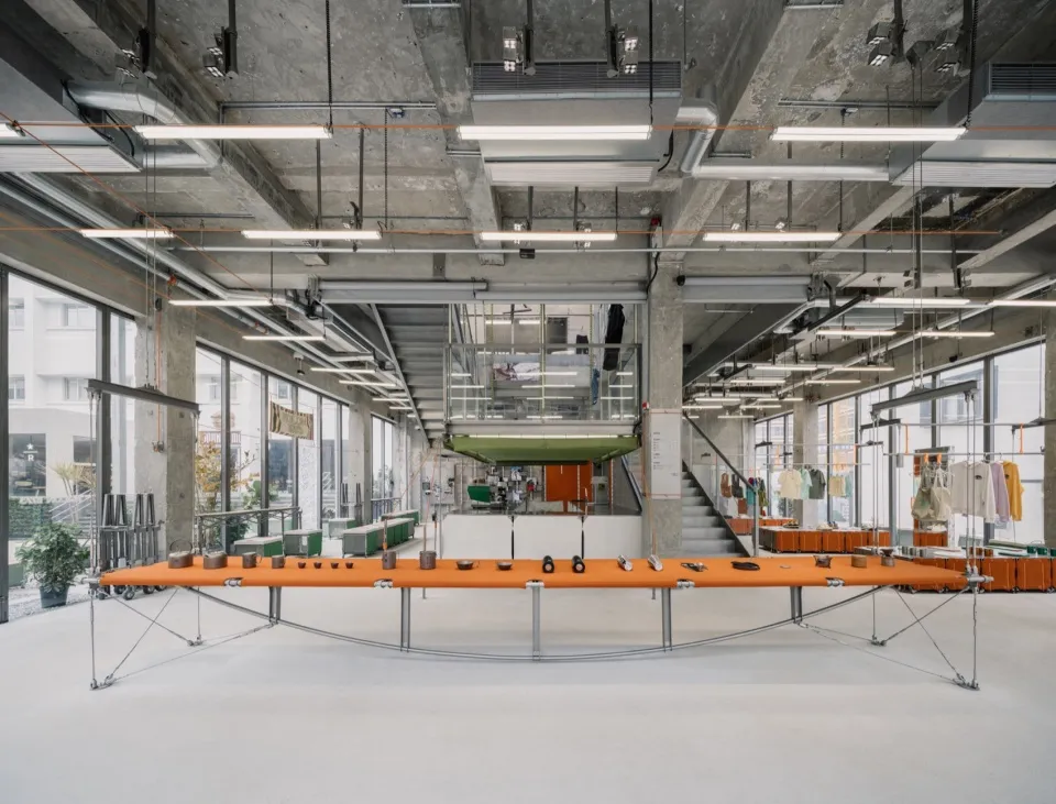 Industrial showroom with concrete, metal, and glass elements.