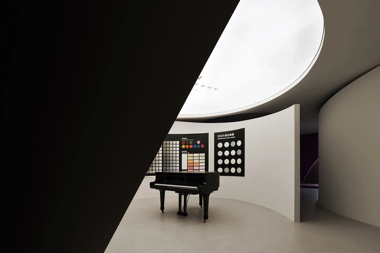 Modern minimalist black and white interior with a piano and color charts.