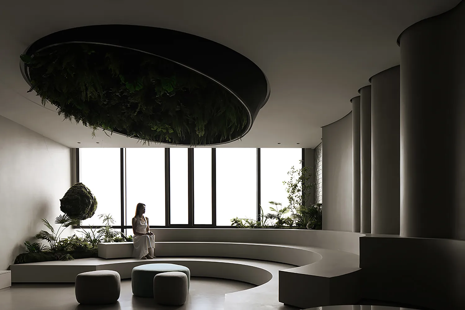 A modern living room with concrete and glass features.