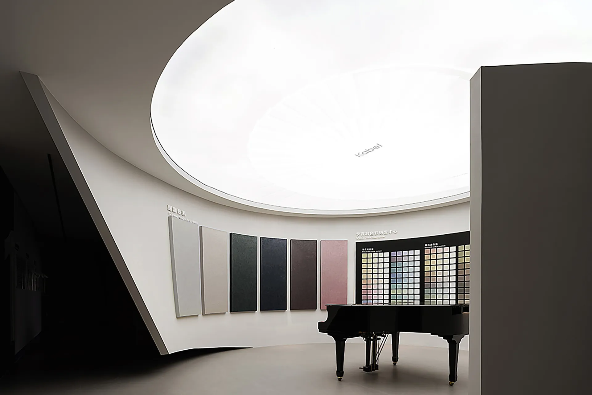 A modern piano room with a black grand piano, white ceiling, and white walls.