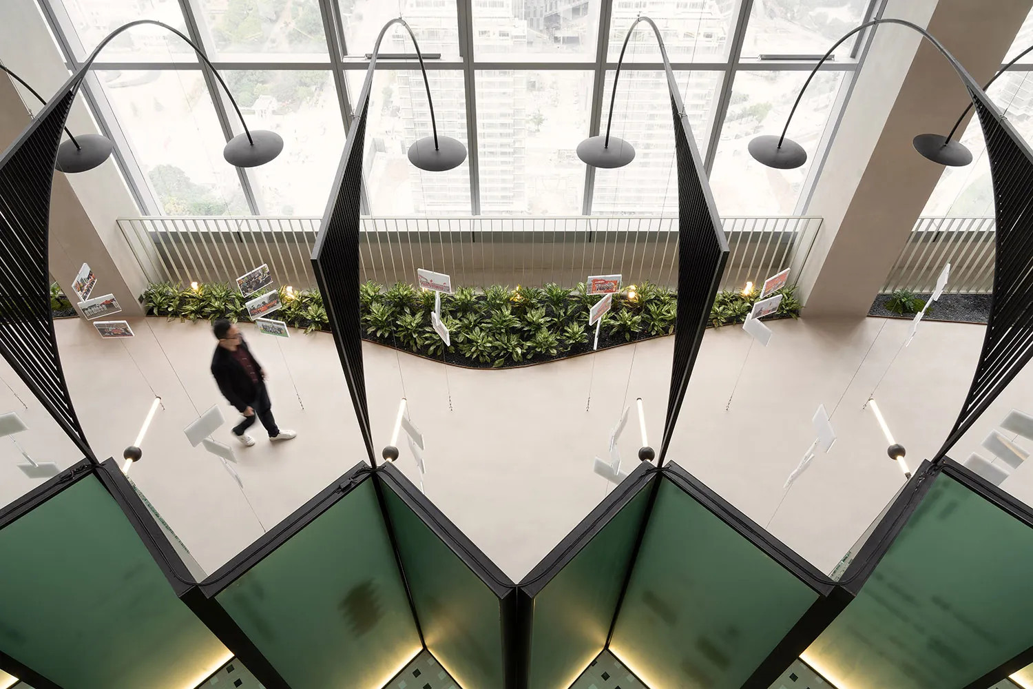 A modern office space featuring a sleek staircase made of glass and metal.