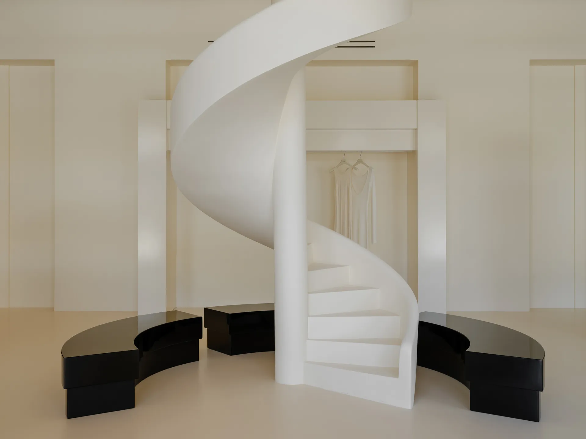 White minimalist retail space with a spiral staircase.