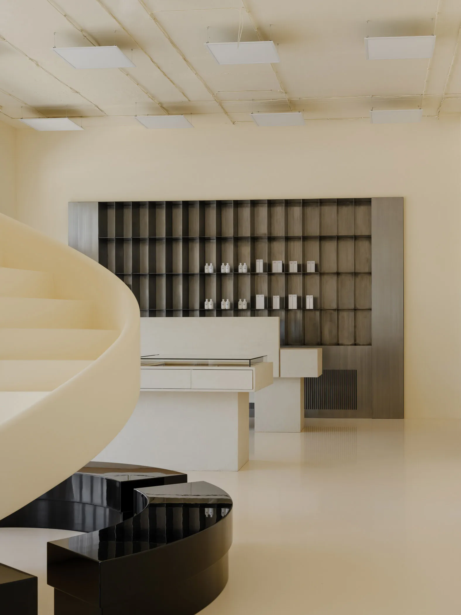 Modern retail shop interior with minimalist design elements and a white color palette.
