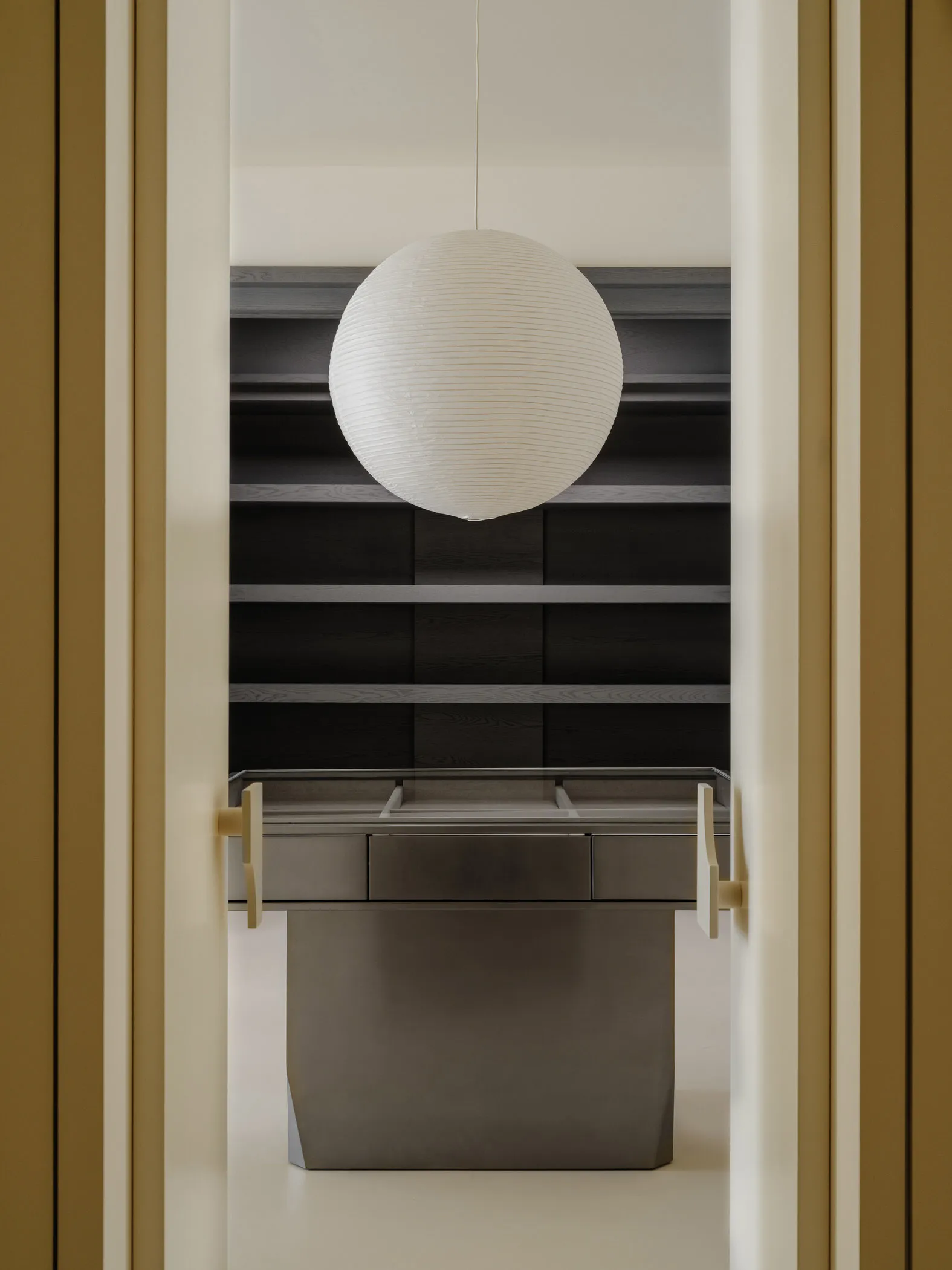 A minimalist wardrobe with metallic drawers and shelves.