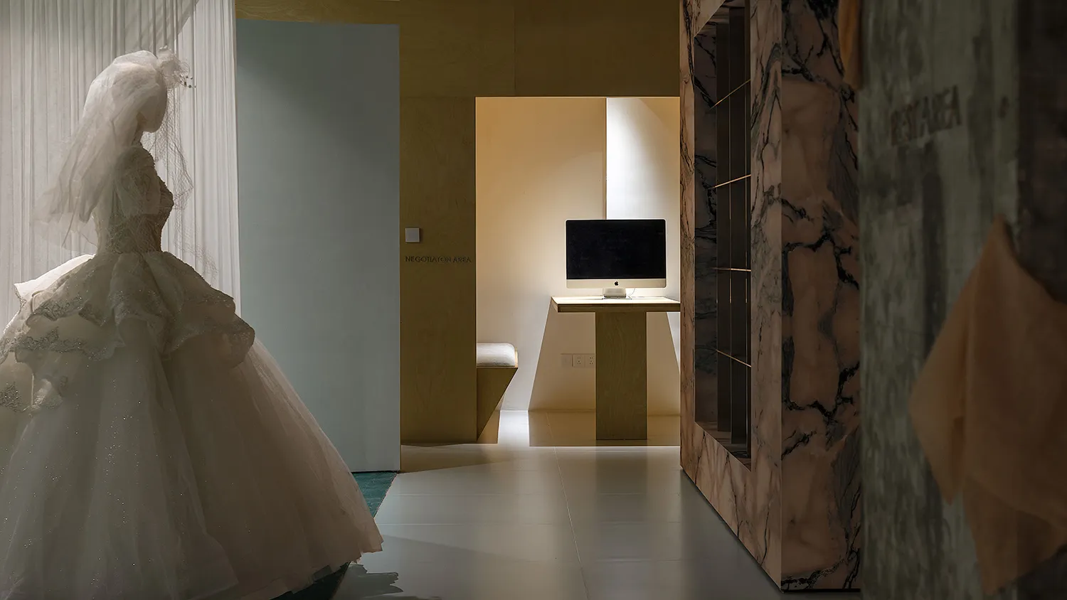 An office space featuring minimalist design with marble and wood elements.