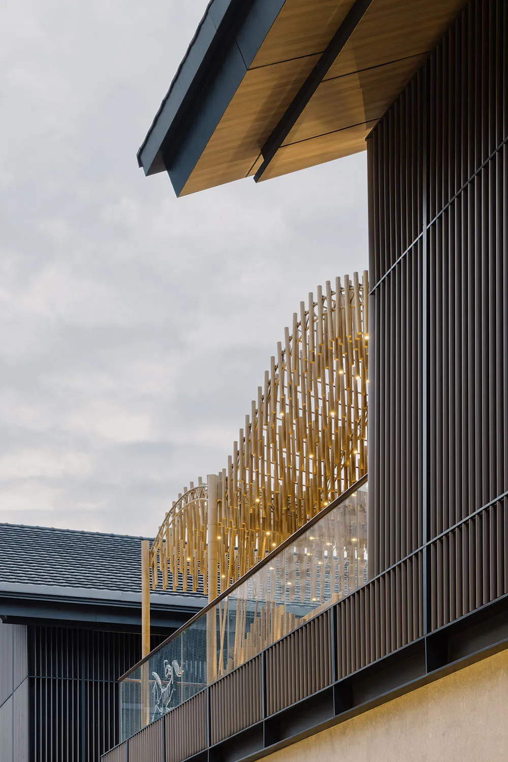 Modern building exterior featuring sleek metal, wooden, and glass architectural elements.