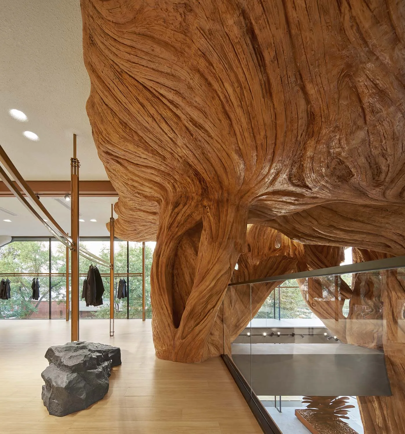 A modern lounge area featuring a large wooden art installation.