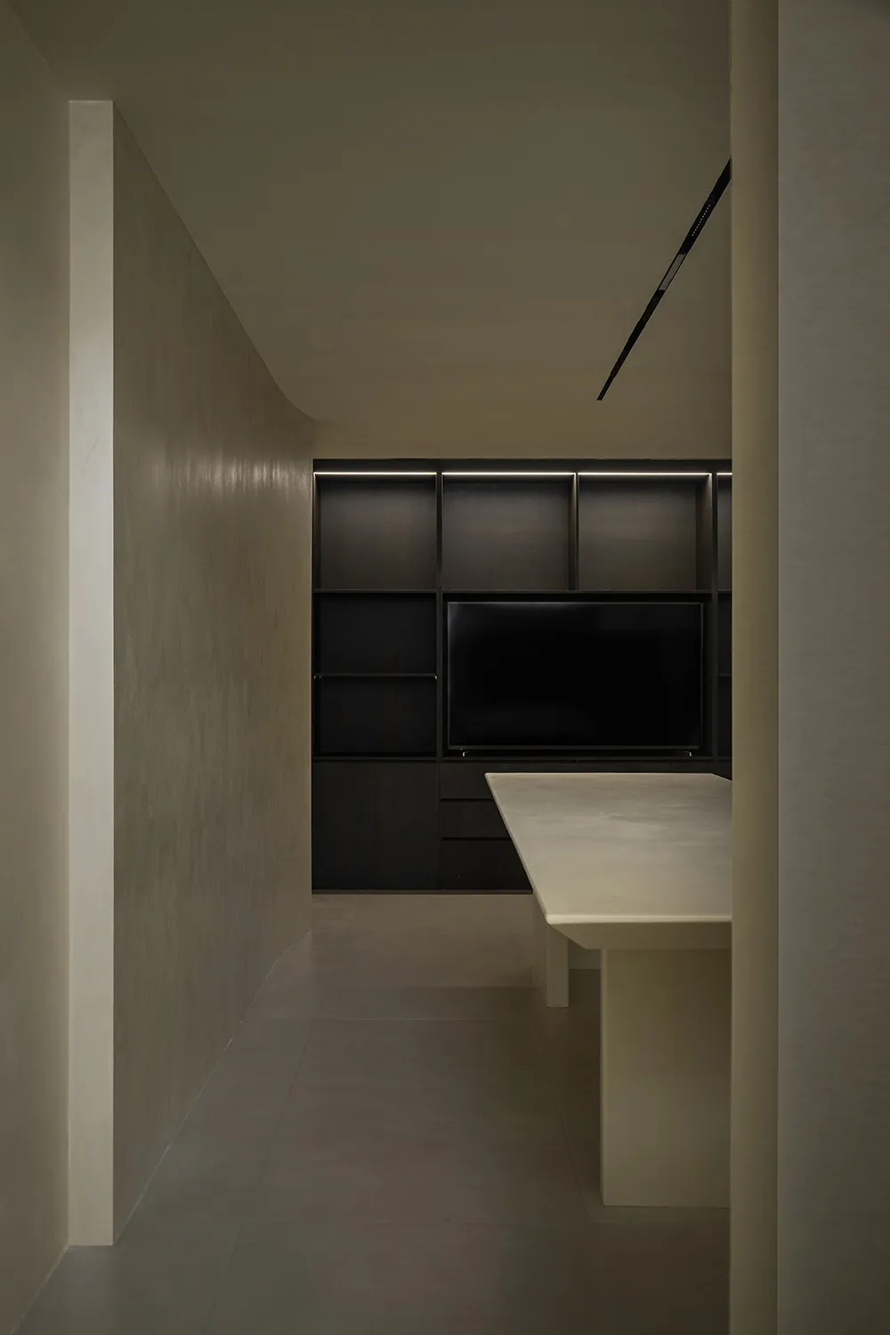 A modern kitchen with a concrete countertop and minimalist design.