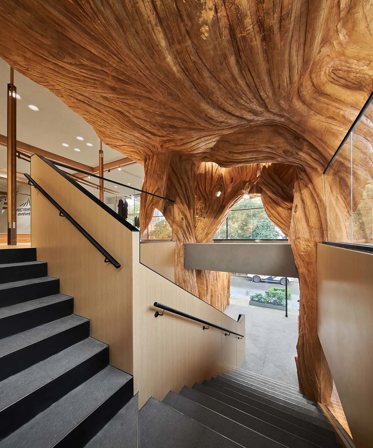 Modern staircase featuring textured wooden panels and railing