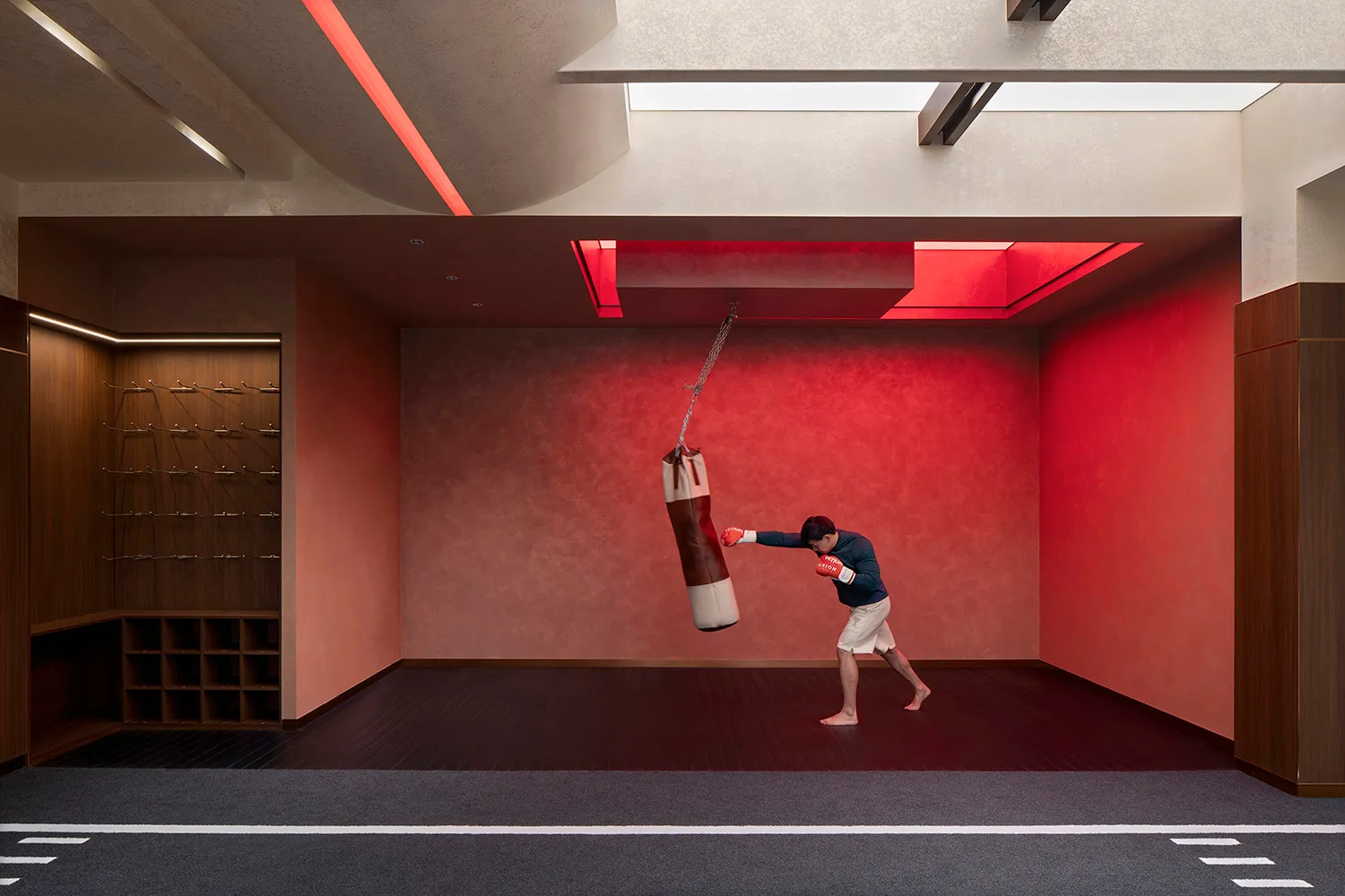 Boxing gym with a concrete floor and red lighting