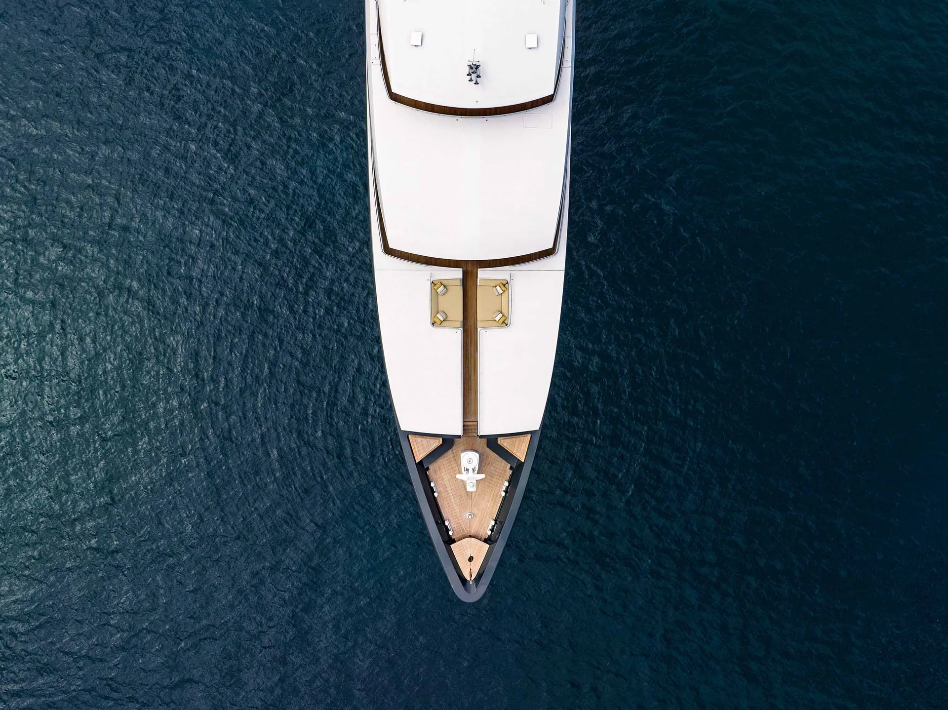 Aerial view of a white yacht looking down.
