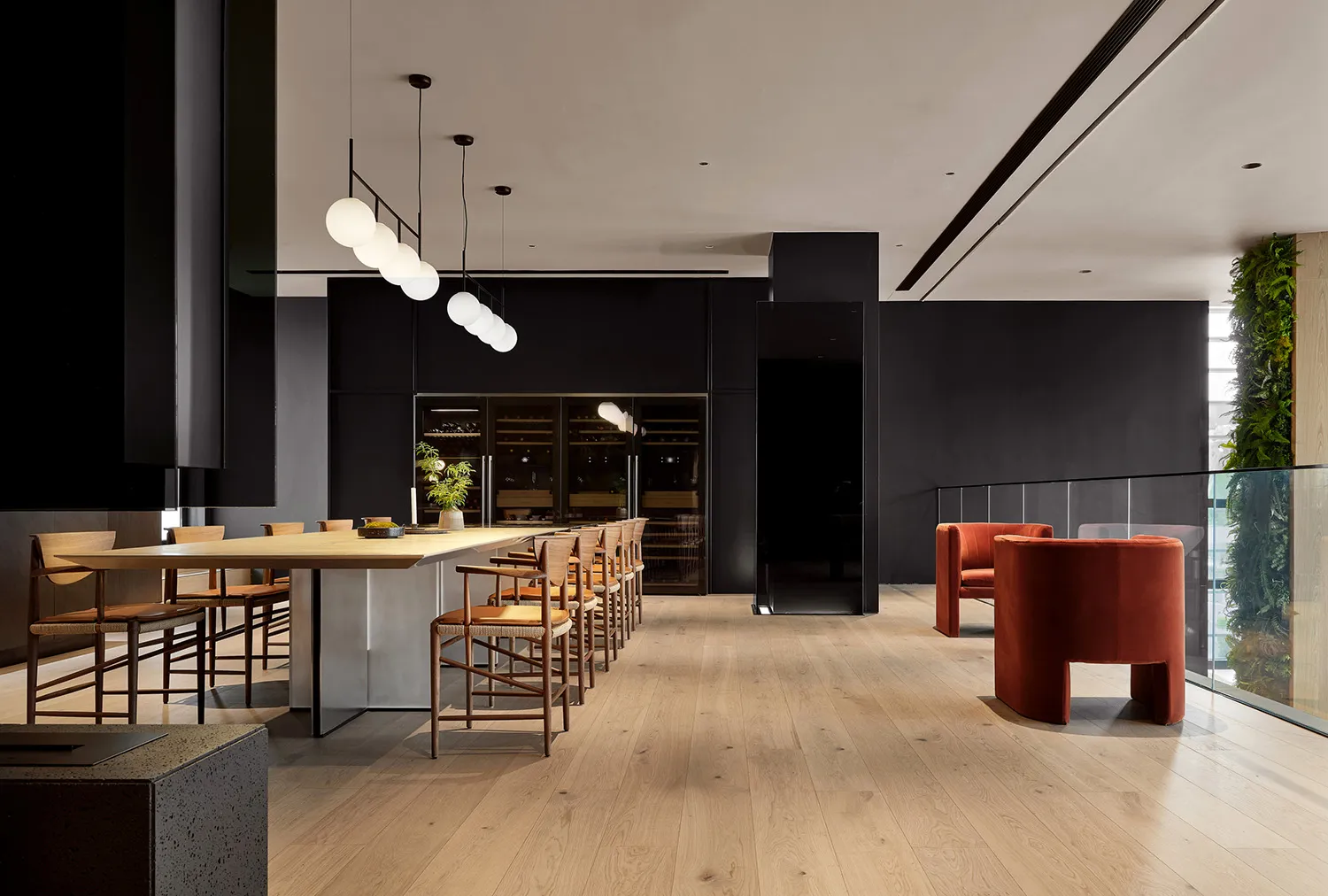 Industrial lounge featuring wooden floors, metal accents, and greenery.