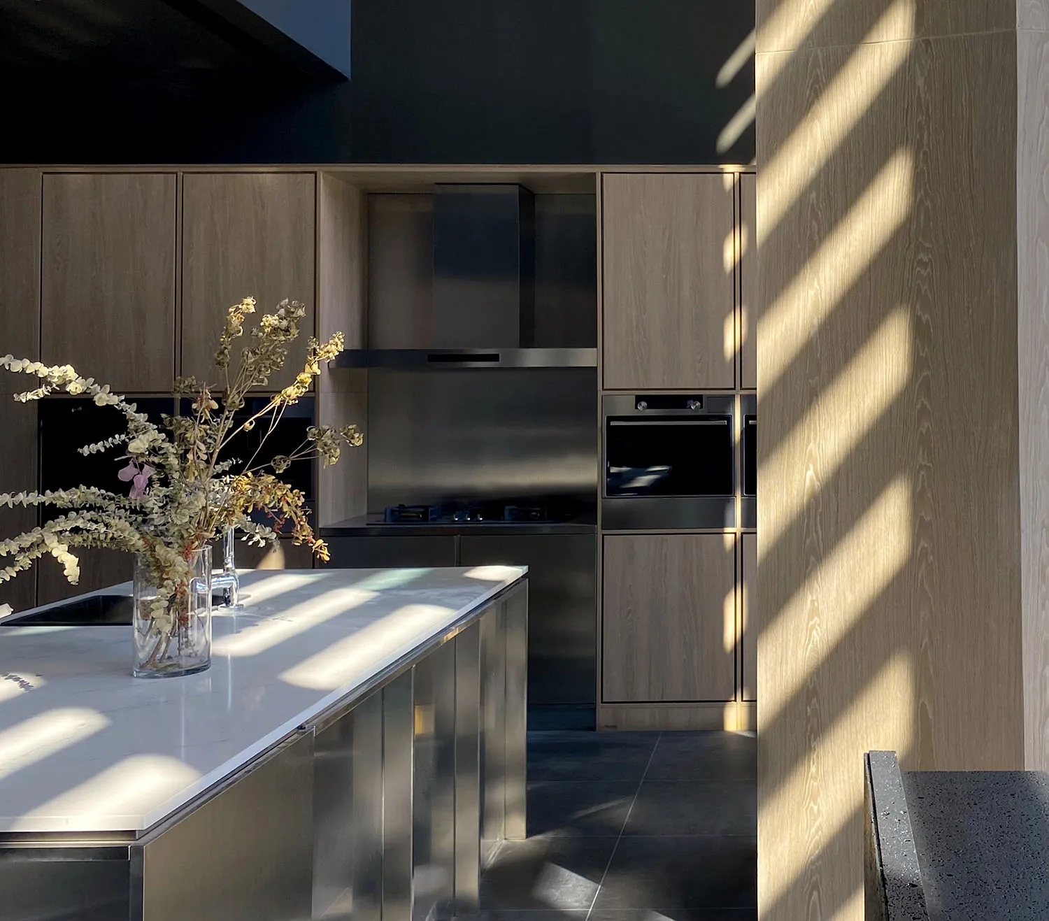 Contemporary kitchen featuring wooden cabinetry and stainless steel appliances