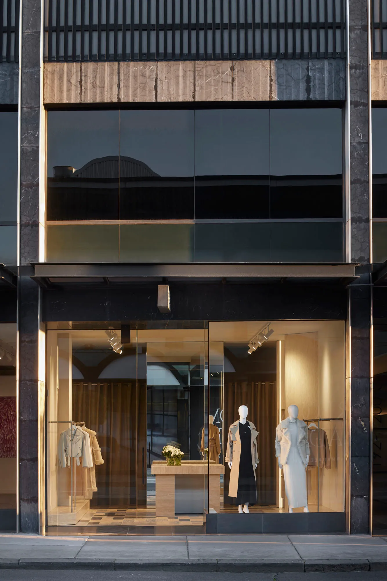Modern retail storefront with glass front displaying clothing