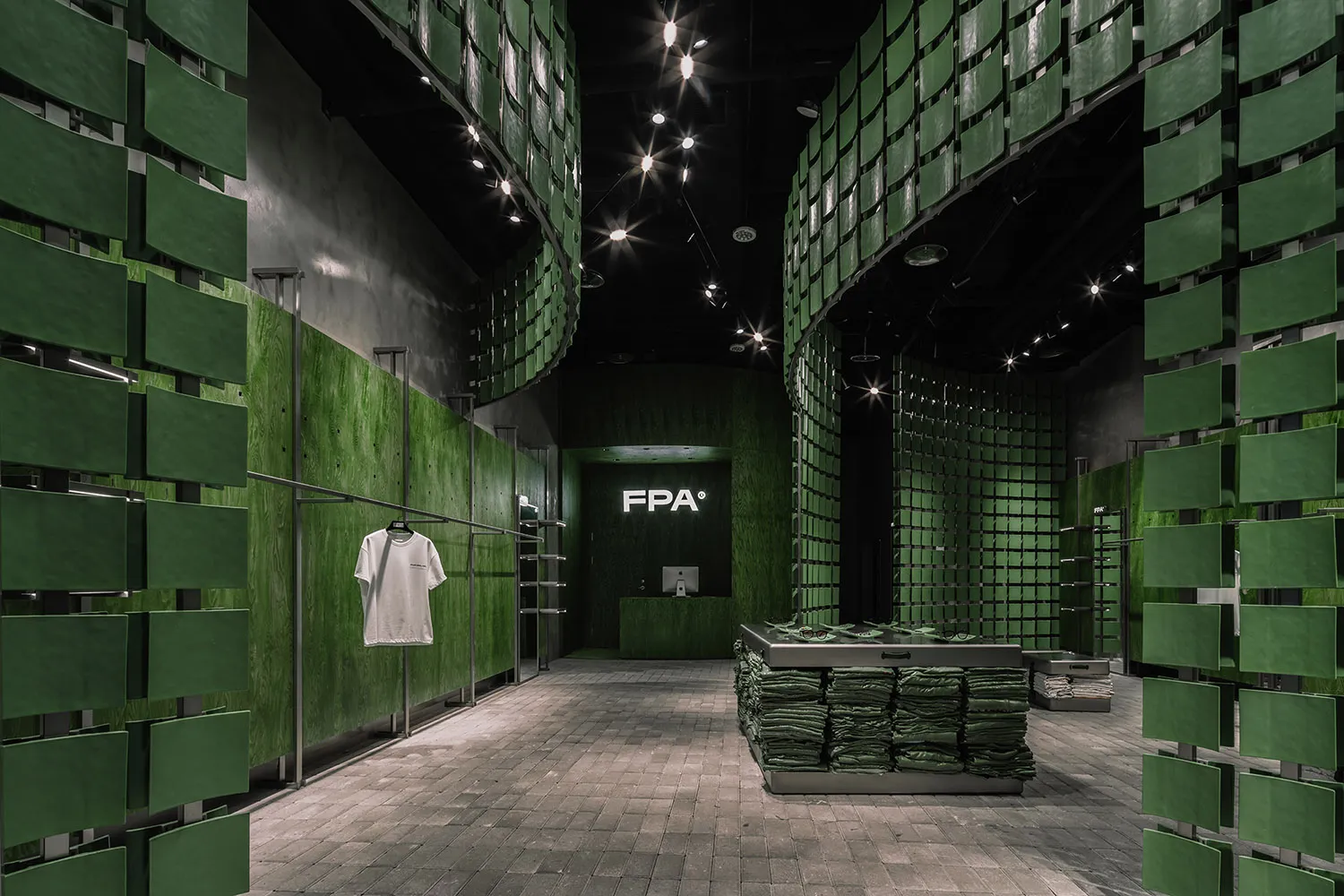 A retail shop interior with green tiled walls and floors.