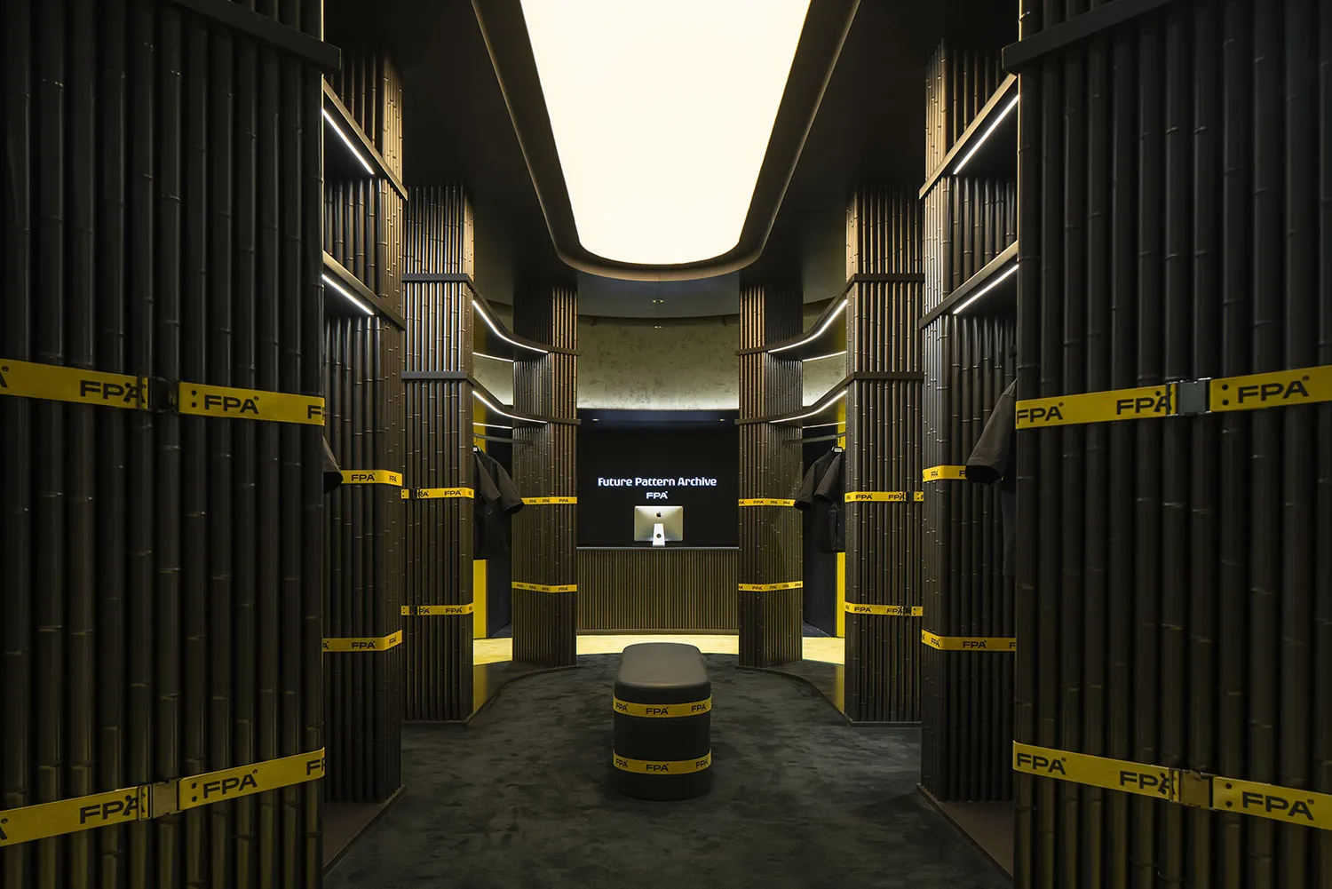 A minimalist clothing retail store featuring wood walls and yellow tape accents