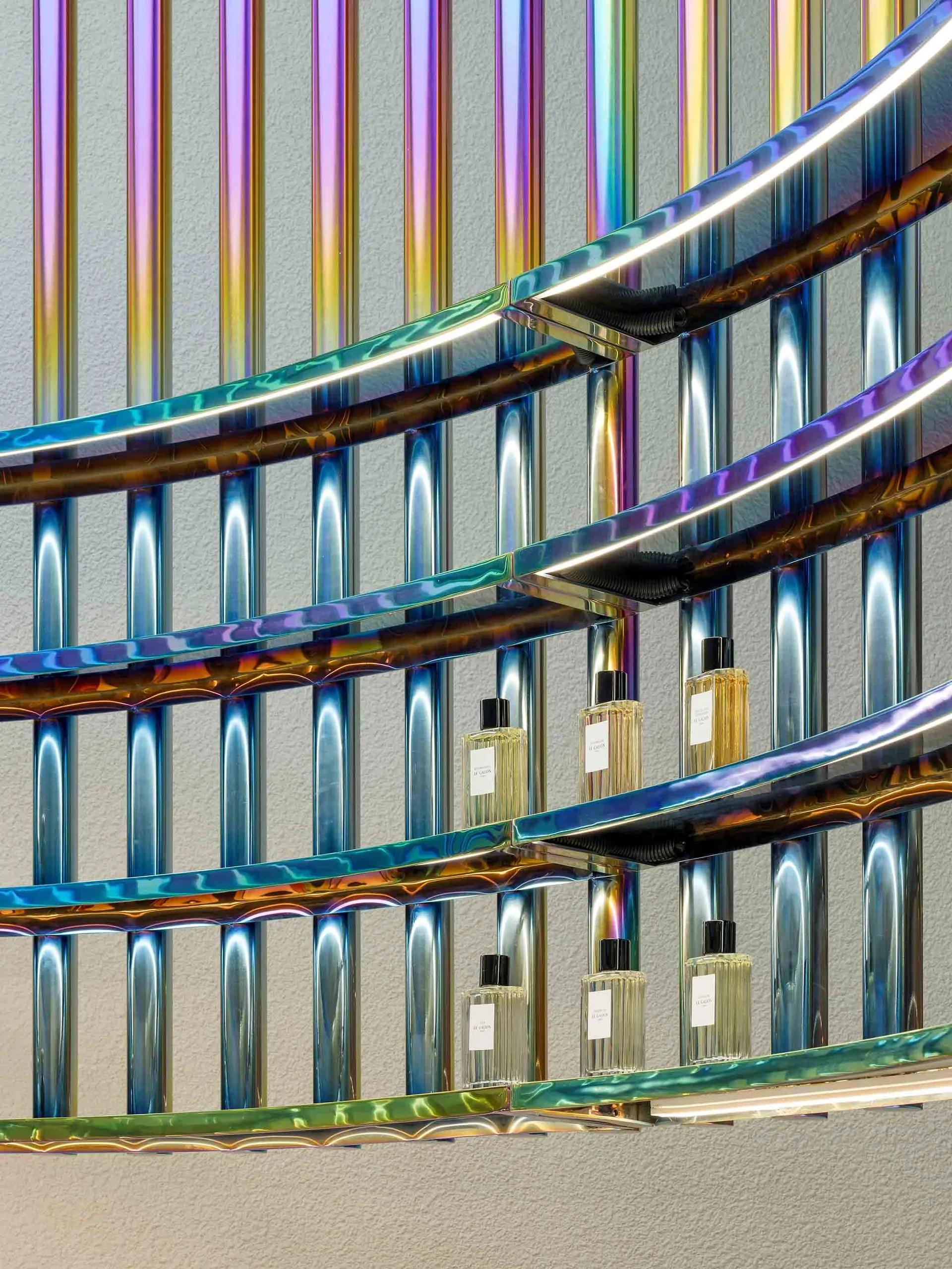 Modern interior design featuring metallic, iridescent finishes and circular stairwell