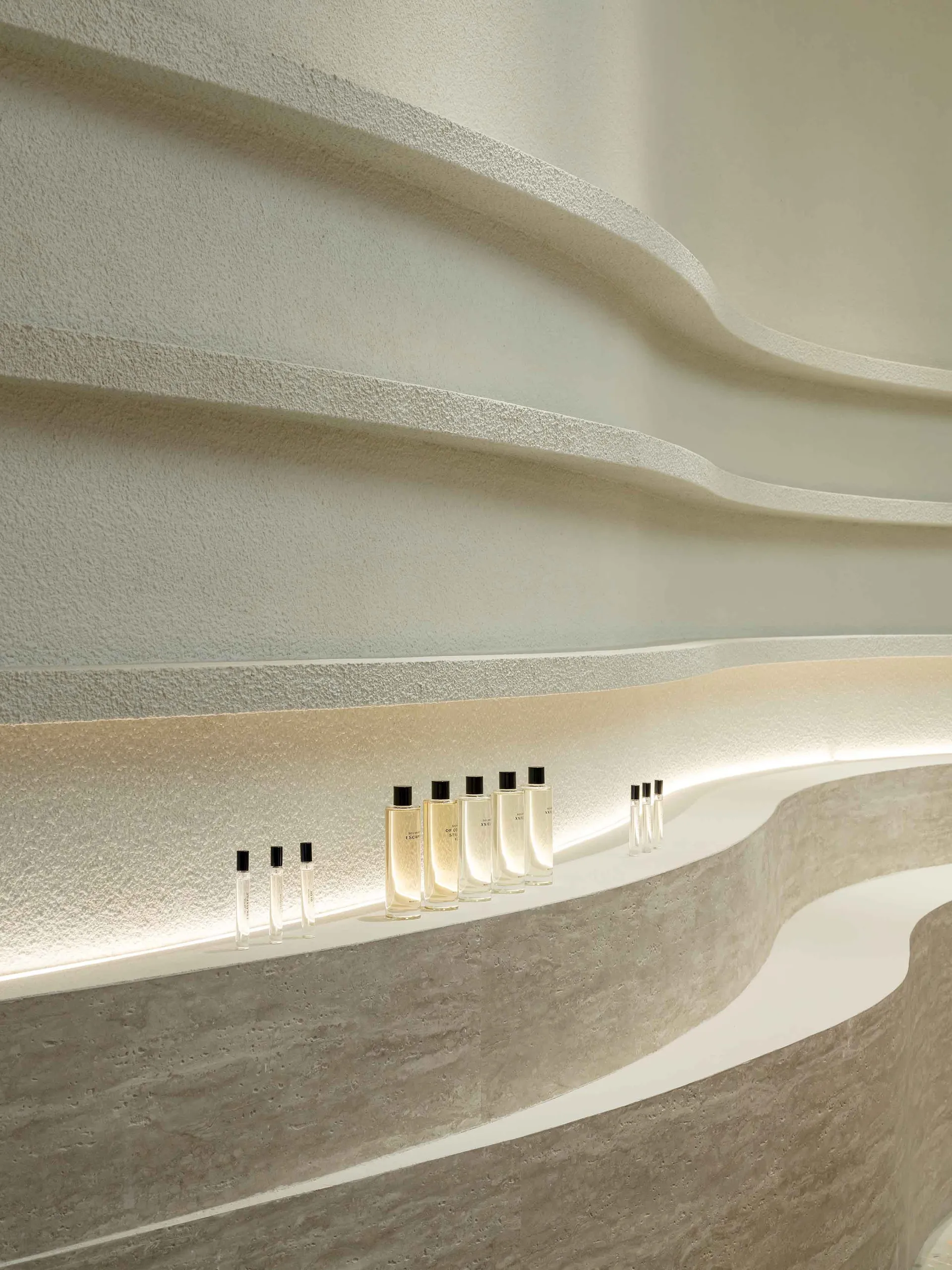 A modern storefront with stone walls and a curved design