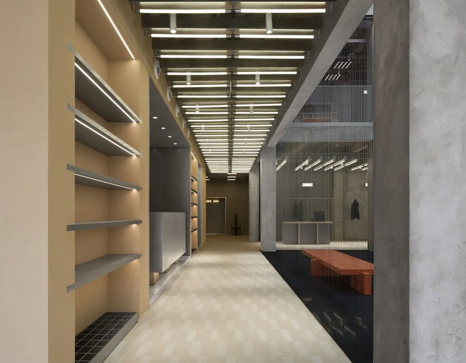 Industrial storefront with exposed concrete walls and a minimalist design.