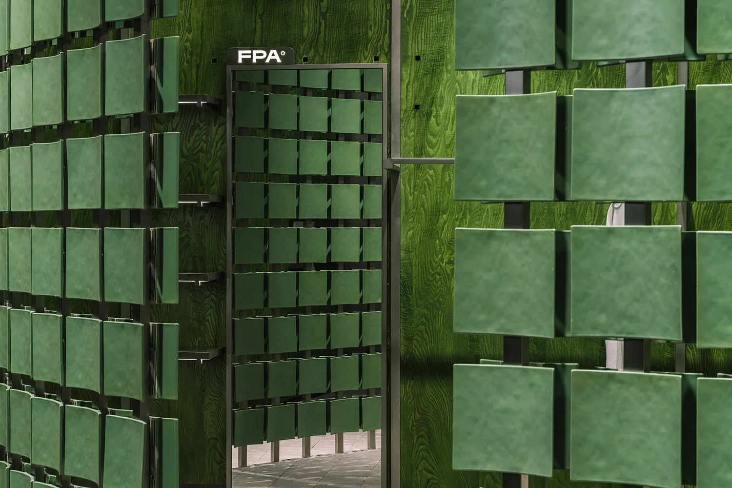 Modern storefront featuring glass panels on a green wooden exterior