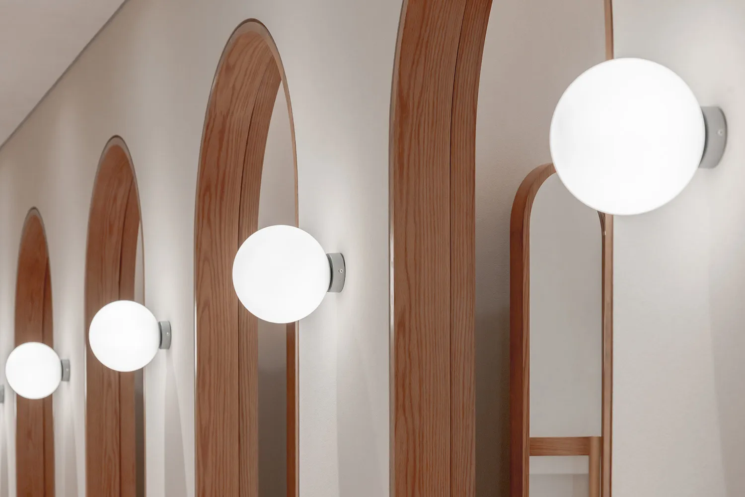Modern interior design featuring minimalist lighting fixtures and wooden panels.