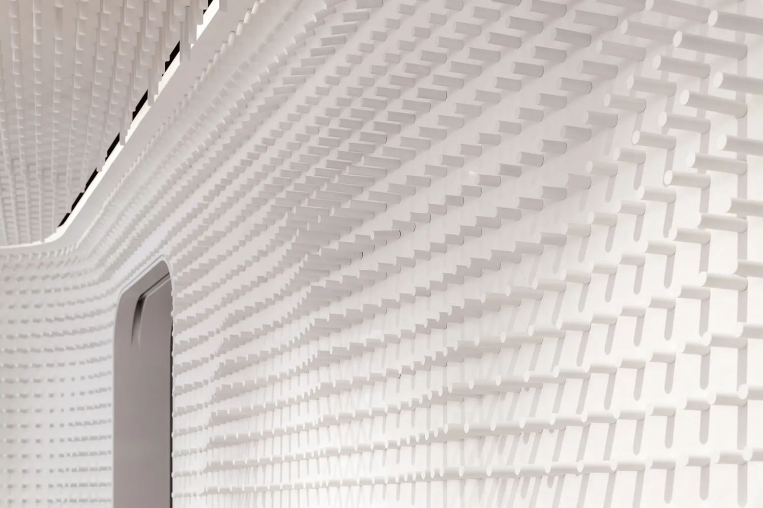 A modern white interior design with a textured plastic wall pattern