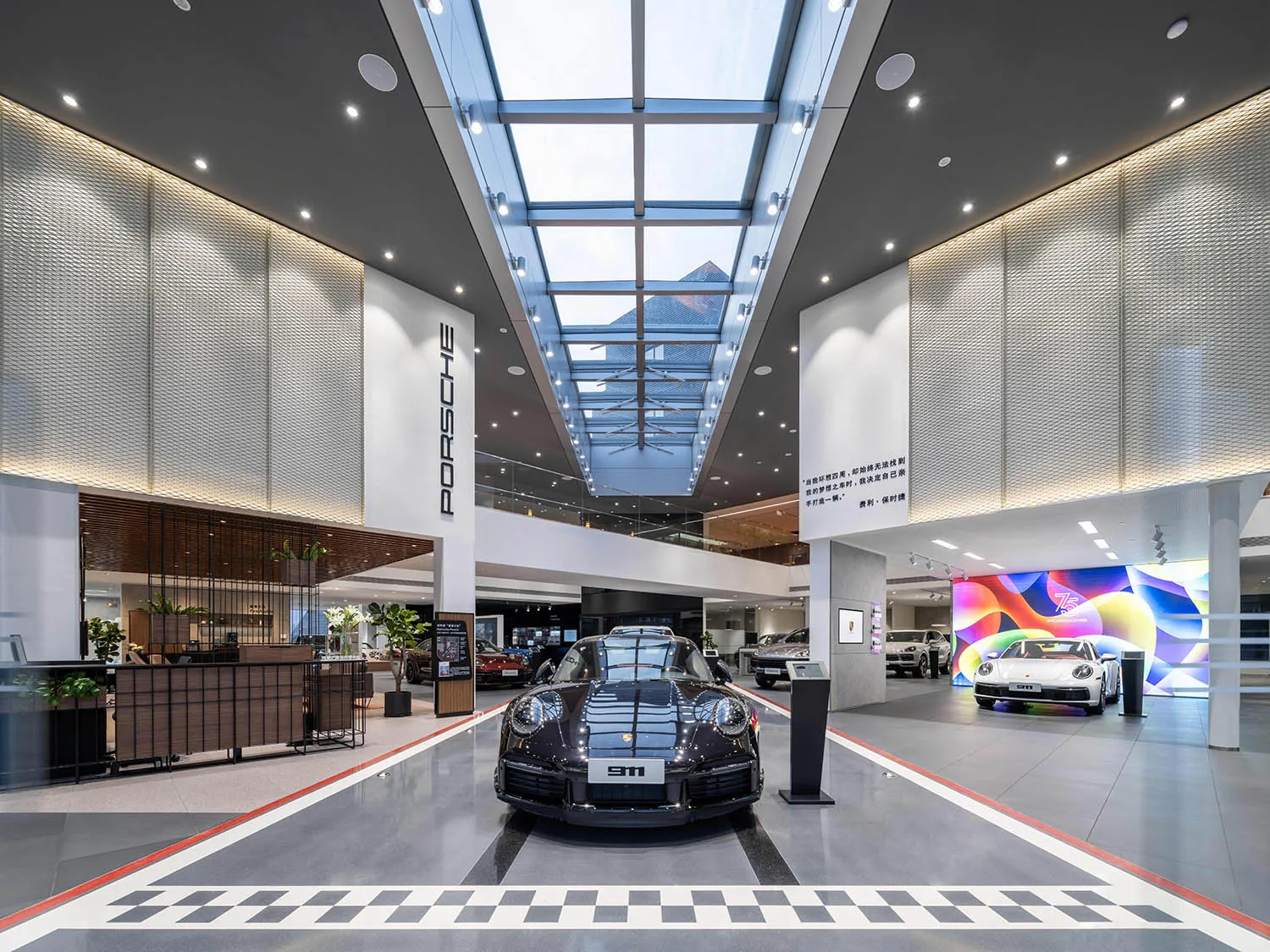 A sleek, modern car showroom with a steel, concrete, and glass interior showcasing a sports car on display.