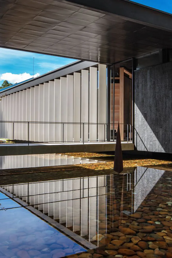 A modern architectural design featuring concrete materials and open spaces.