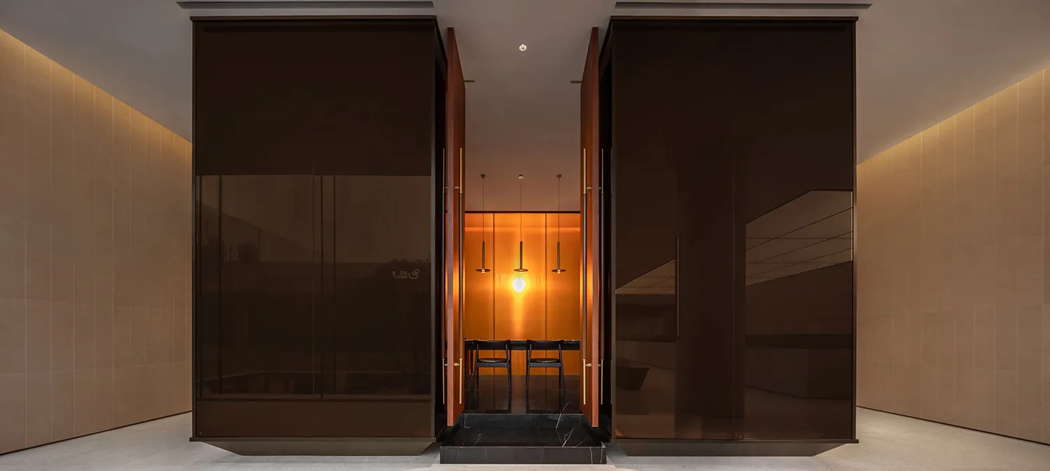 A modern lobby featuring glass and wooden elements.