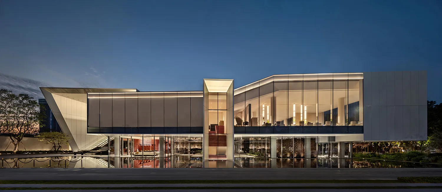 Modern architectural building with glass exterior at dusk
