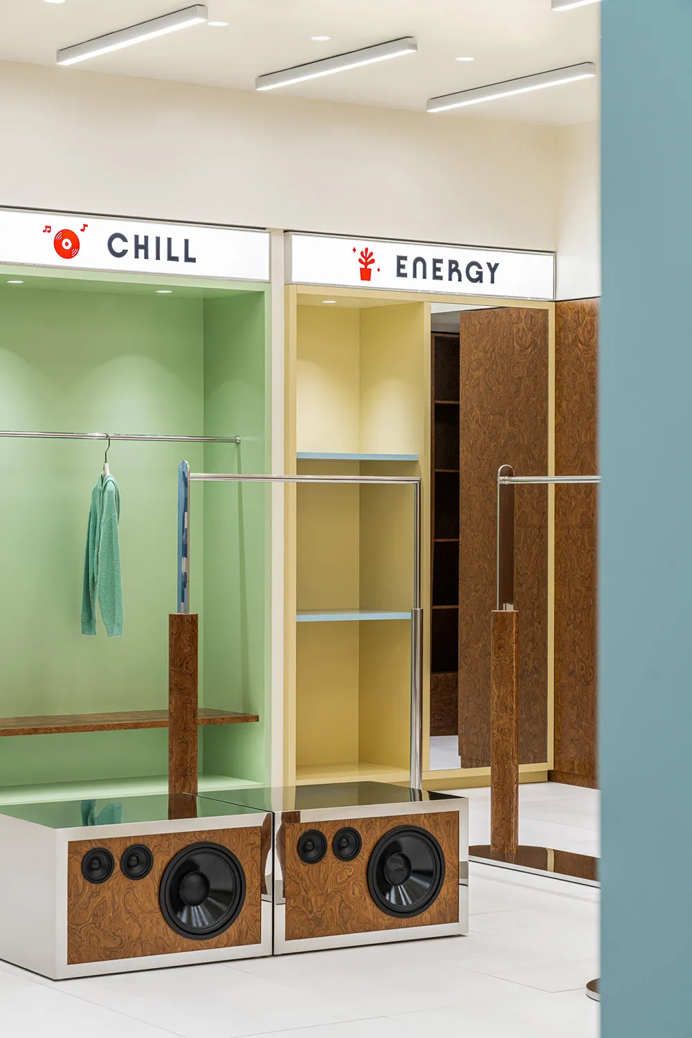 Modern clothing retail store featuring metal shelves and clothing racks.