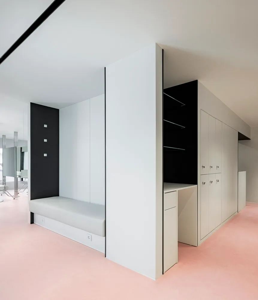 Modern minimalist office space featuring clean lines, concrete, glass, and metal materials.