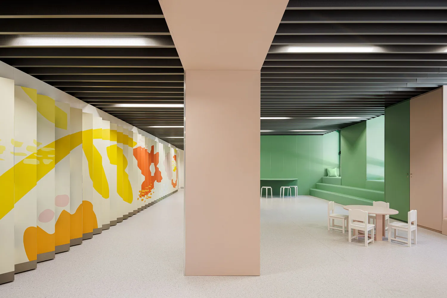 A modern playroom features colorful patterns on the walls, designed for children's entertainment.