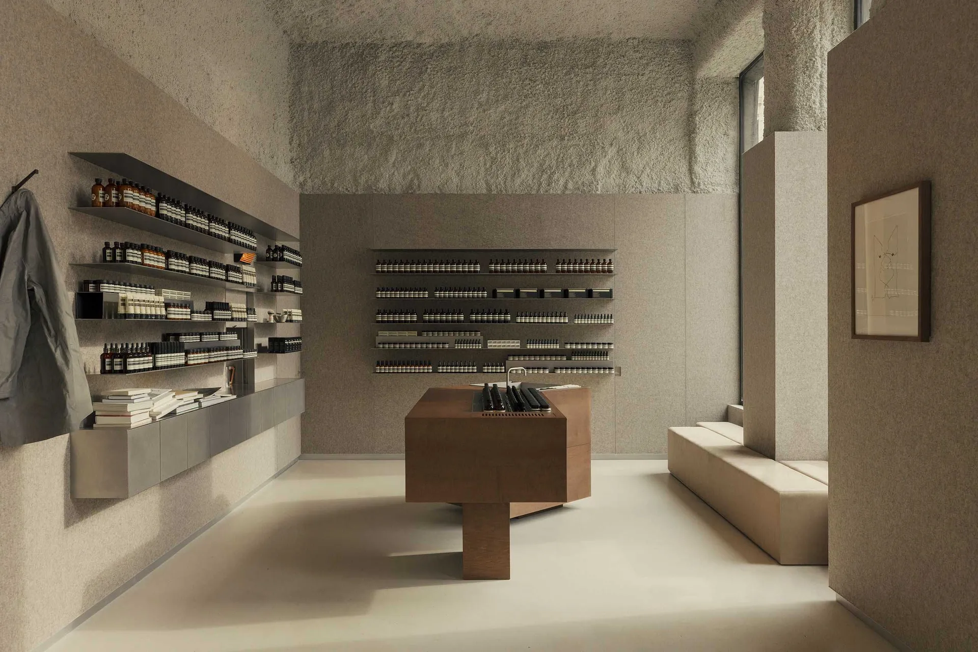 A modern retail storefront with minimalist design, featuring concrete walls and wood elements.