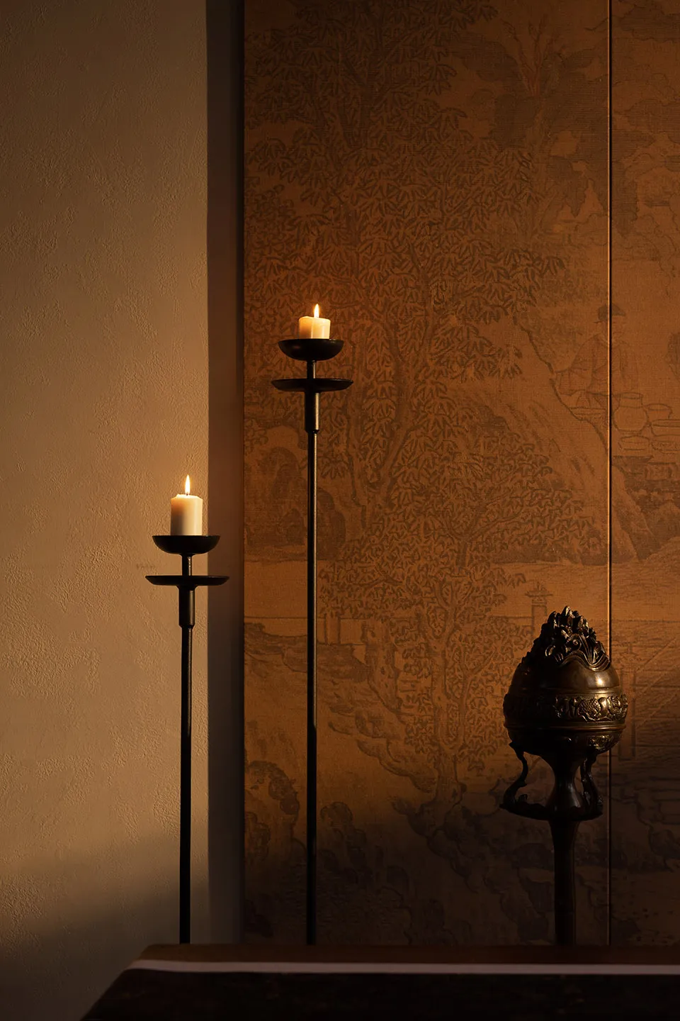 A lit candelabrum and a decorative object in an indoor setting.