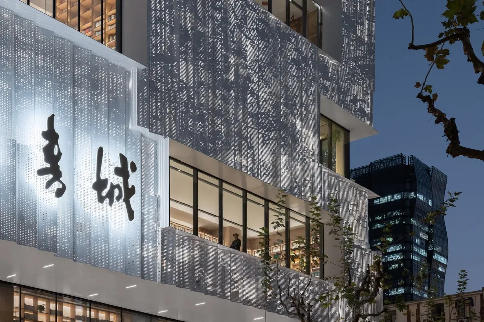 A modern building facade featuring mirrored metal panels