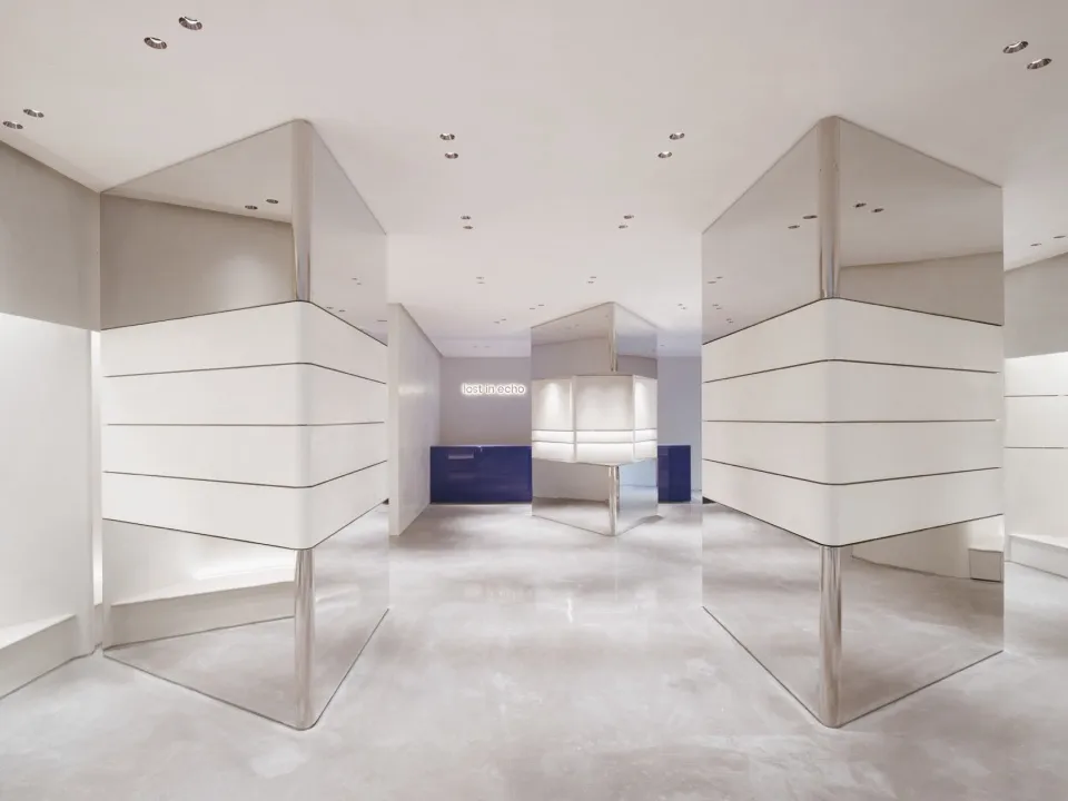 Modern minimalist retail space featuring glass paneling walls and floors