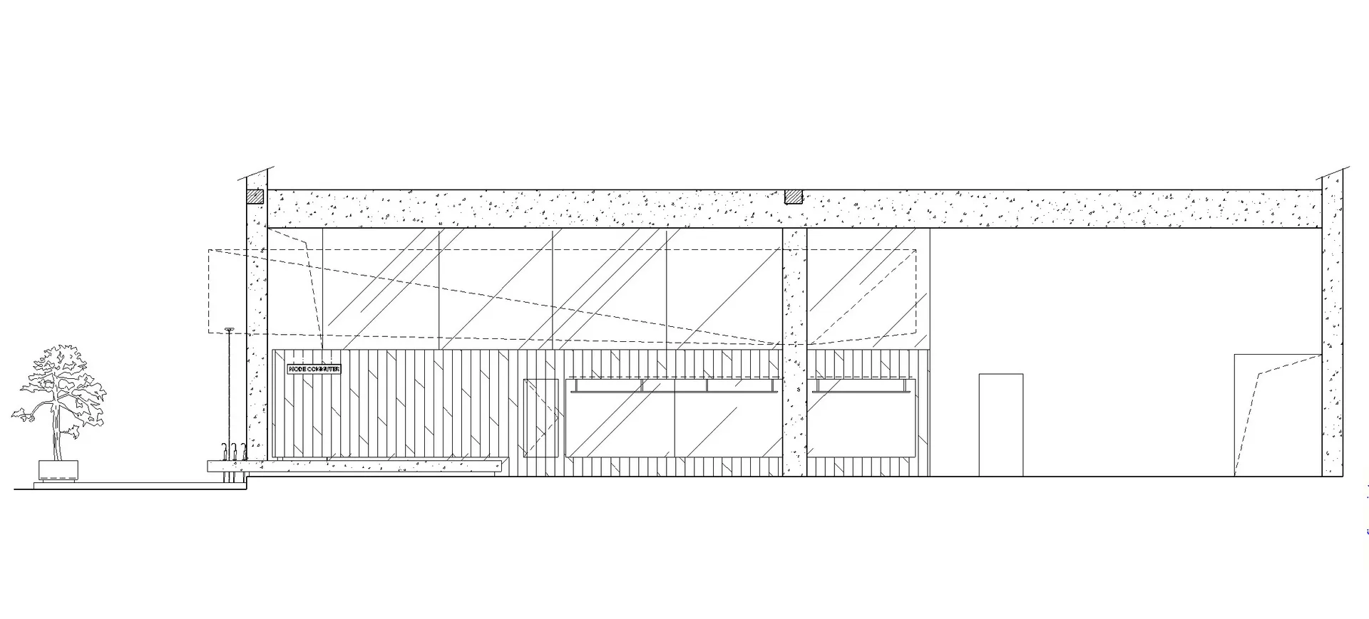 A modern building exterior with large glass panels and a steel frame.