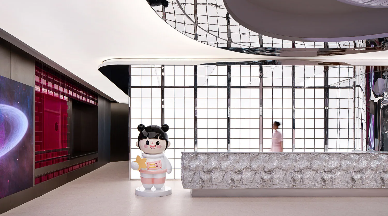 A modern retail storefront with a metal foil and canvas exterior and concrete elements.
