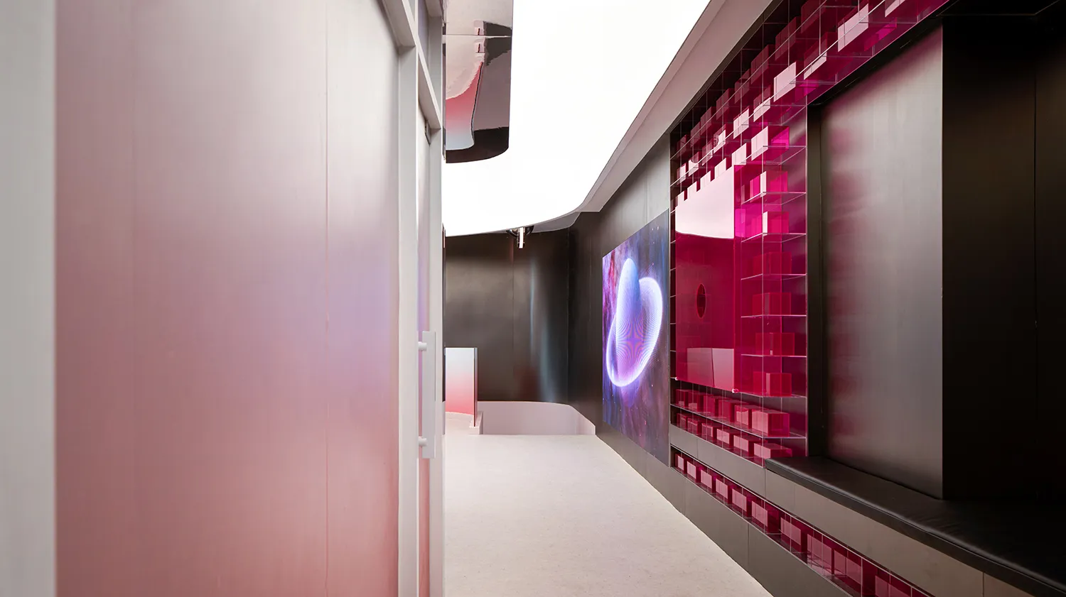 A digital space display featuring vibrant pink and purple colors and geometric patterns.